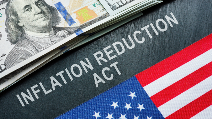 USA flag, dollars and inscription inflation reduction act.