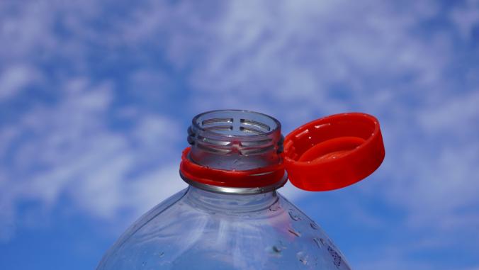Image of a plastic bottle with a red cap.