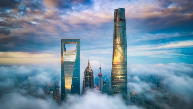 A nighttime image of the Shanghai skyline in clouds.